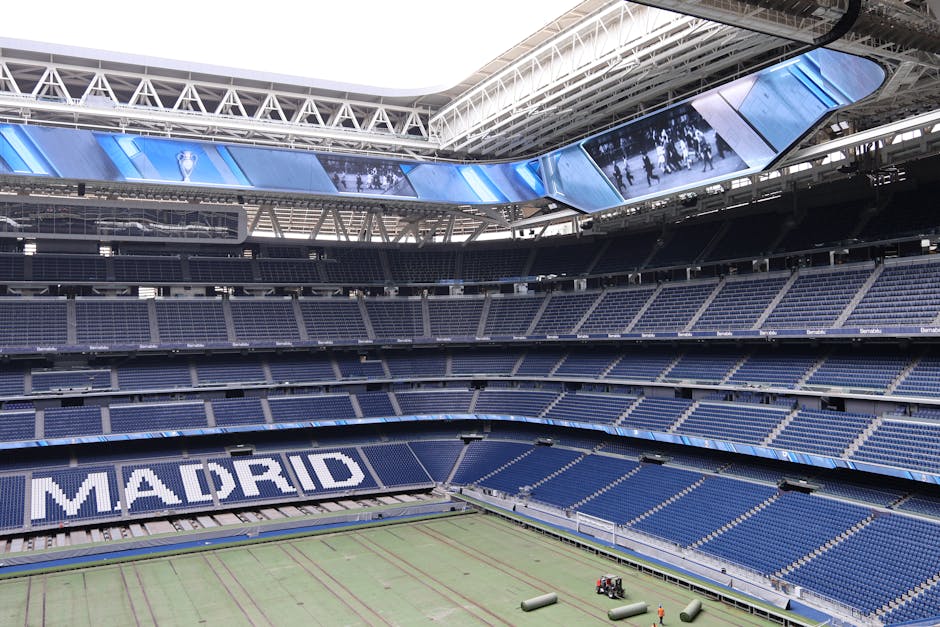 Explore the modern architecture of Santiago Bernabéu Stadium in Madrid, Spain, with its iconic branding.